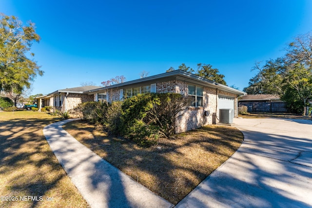 view of front of home featuring a garage and central air condition unit