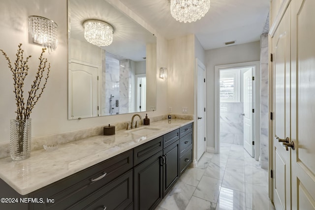 bathroom with marble finish floor, visible vents, vanity, and an inviting chandelier