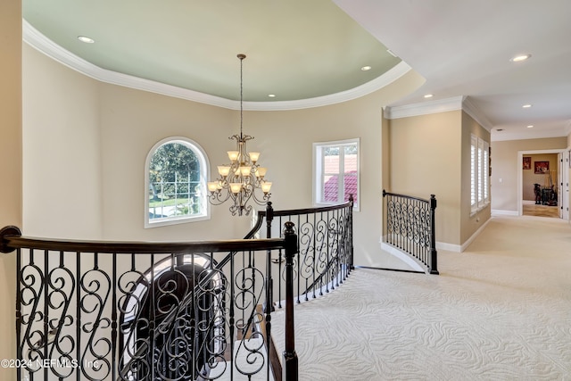 corridor with baseboards, a wealth of natural light, an upstairs landing, and an inviting chandelier