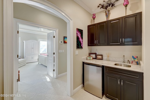 bar with crown molding, light colored carpet, a sink, dishwasher, and baseboards