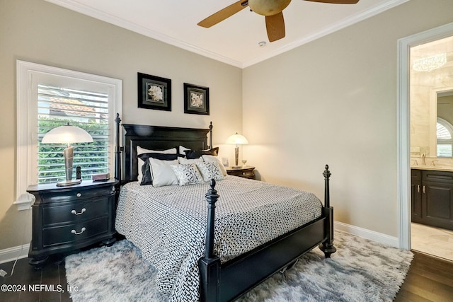 bedroom with crown molding, ensuite bath, baseboards, and wood finished floors