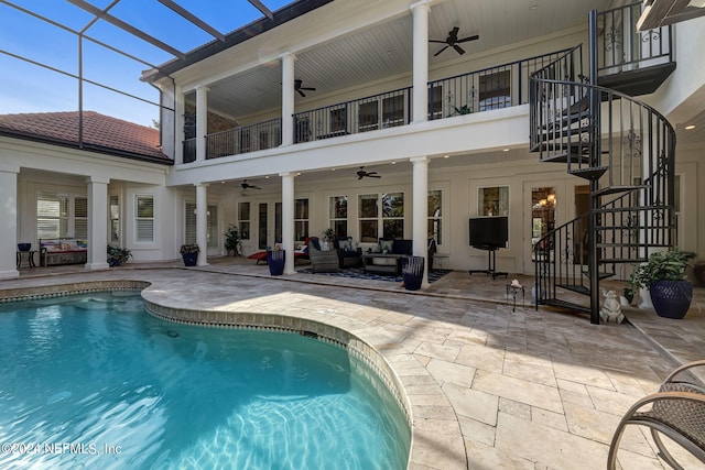 back of house with a ceiling fan, a lanai, a patio, and stairs