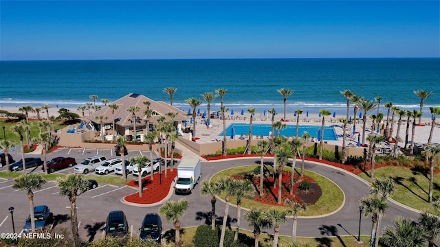 birds eye view of property featuring a beach view and a water view