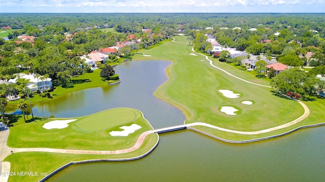 aerial view with golf course view and a water view