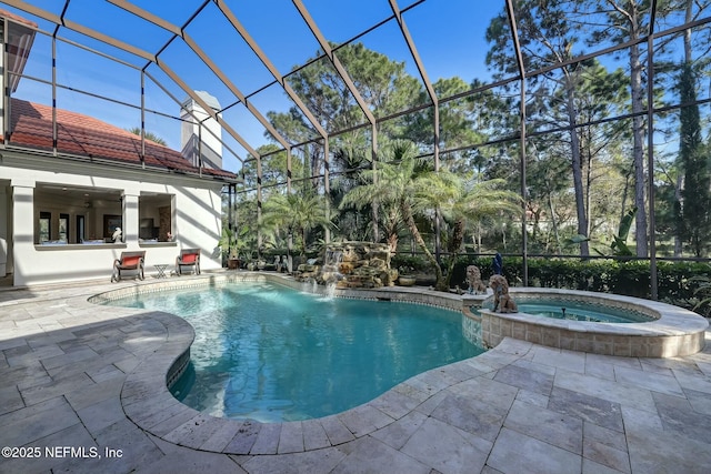 view of swimming pool featuring a patio area, a lanai, and a pool with connected hot tub