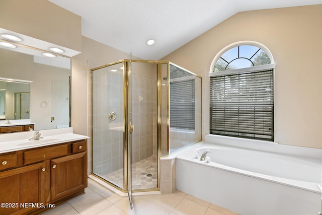 bathroom with tile patterned flooring, vaulted ceiling, vanity, and plus walk in shower