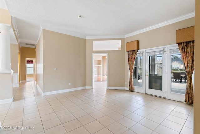 tiled spare room with crown molding, decorative columns, and a textured ceiling