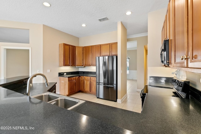 kitchen with sink, ornamental molding, black appliances, a textured ceiling, and light tile patterned flooring