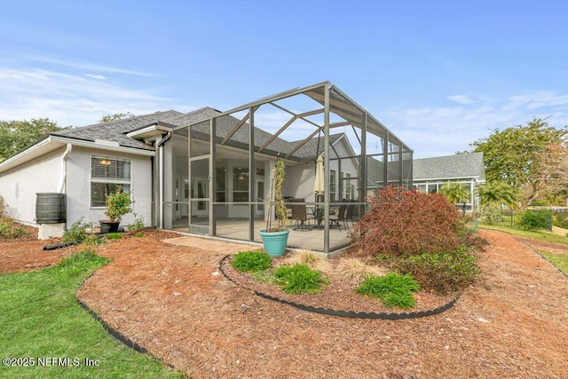 rear view of house featuring a lanai, cooling unit, and a patio area