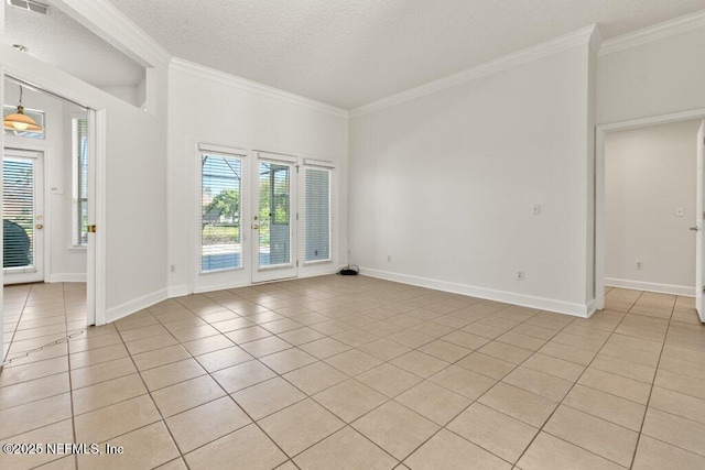 spare room featuring visible vents, a textured ceiling, light tile patterned flooring, crown molding, and baseboards