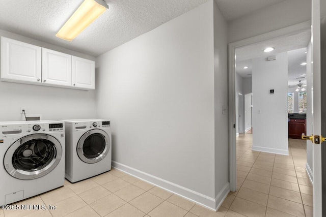 laundry room with a ceiling fan, light tile patterned flooring, cabinet space, and independent washer and dryer