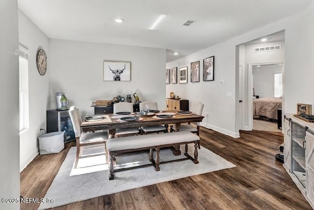 dining space with dark hardwood / wood-style floors