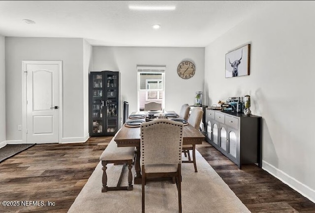 dining area featuring dark wood-type flooring