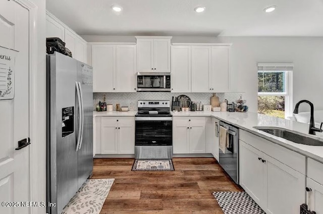 kitchen featuring white cabinetry, sink, and appliances with stainless steel finishes