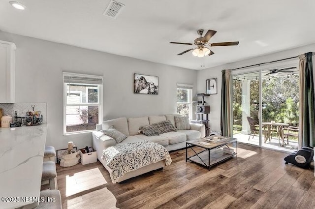 living room with ceiling fan, a healthy amount of sunlight, and wood-type flooring