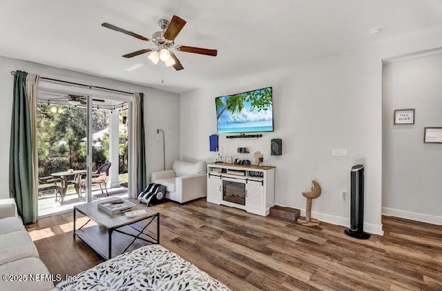 living room with dark hardwood / wood-style floors and ceiling fan