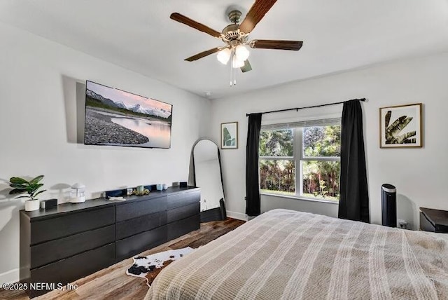 bedroom featuring ceiling fan and dark wood-type flooring