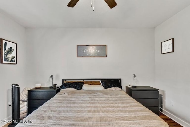 bedroom with ceiling fan and dark hardwood / wood-style floors