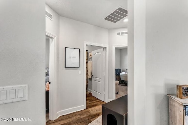 hall with dark wood-type flooring