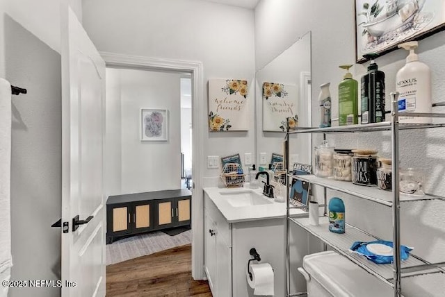 bathroom featuring hardwood / wood-style flooring, vanity, and toilet