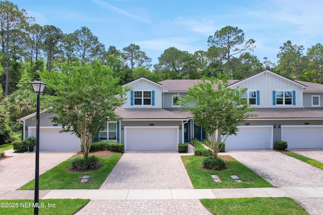 view of front of home with a front yard and a garage