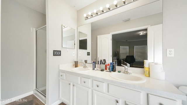 bathroom with vanity, hardwood / wood-style flooring, and walk in shower