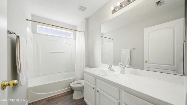 full bathroom with shower / bath combination with curtain, a textured ceiling, toilet, wood-type flooring, and vanity