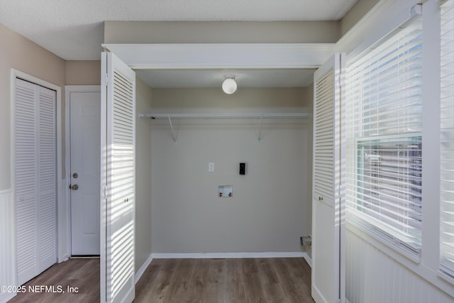 laundry room featuring dark hardwood / wood-style floors, hookup for a washing machine, and electric dryer hookup