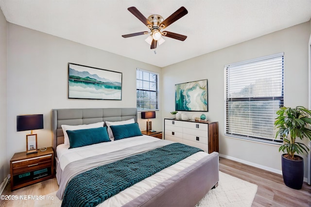 bedroom with ceiling fan and light hardwood / wood-style flooring