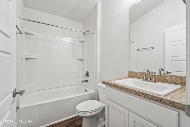 full bathroom with hardwood / wood-style floors, vanity, bathing tub / shower combination, and toilet