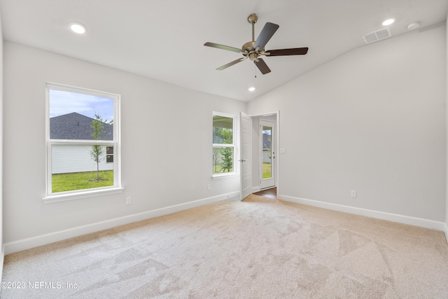 unfurnished room with ceiling fan, light colored carpet, and vaulted ceiling