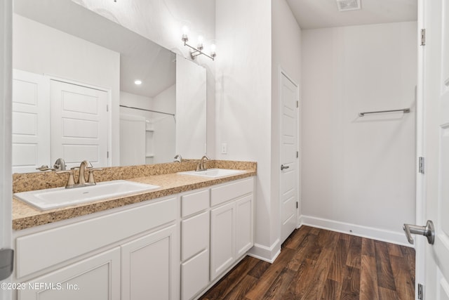 bathroom with vanity and hardwood / wood-style floors