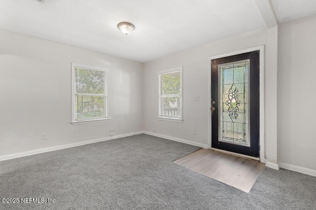 view of carpeted foyer entrance