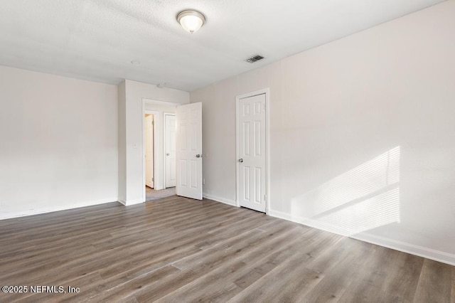 empty room featuring hardwood / wood-style flooring