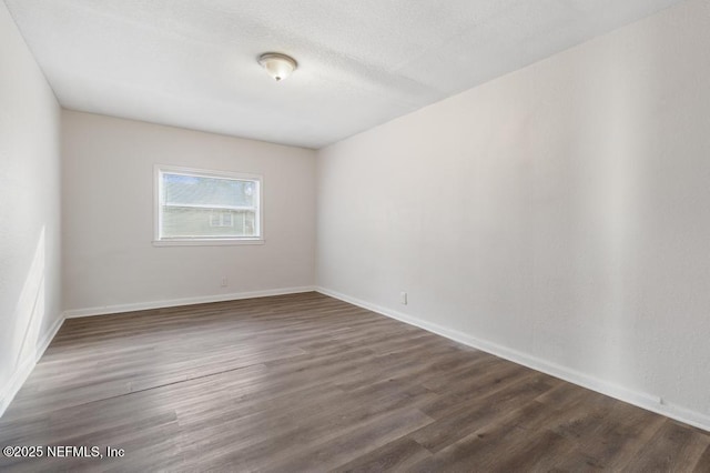 empty room featuring dark hardwood / wood-style floors