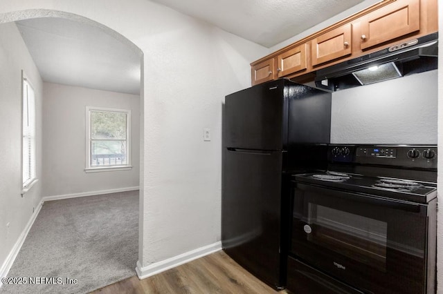 kitchen featuring light hardwood / wood-style flooring and black appliances