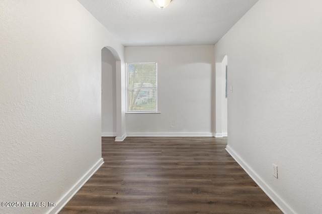 hallway with dark hardwood / wood-style floors