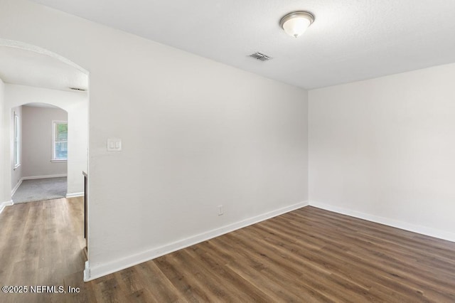 spare room featuring dark hardwood / wood-style floors