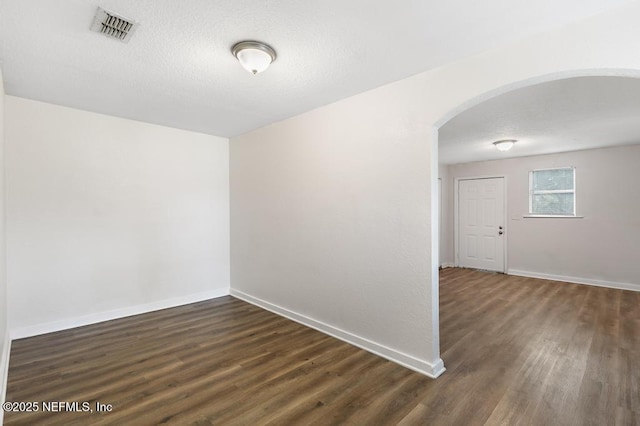 unfurnished room featuring dark hardwood / wood-style flooring