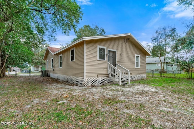 rear view of property with cooling unit