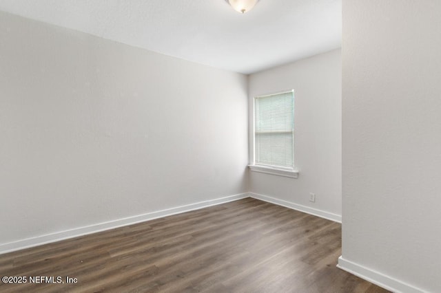 unfurnished room featuring dark wood-type flooring