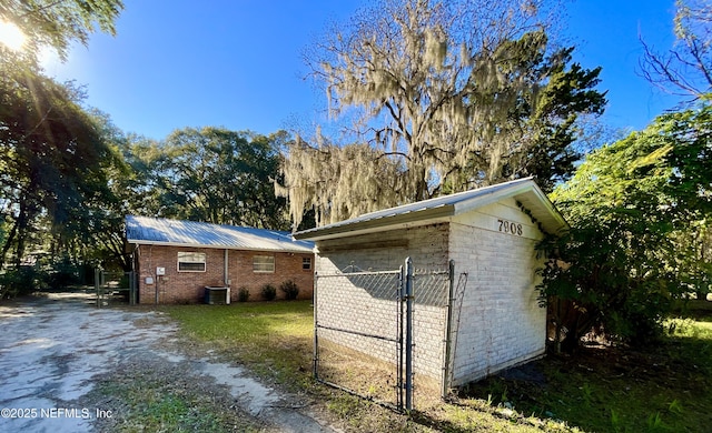 view of property exterior featuring central AC and an outdoor structure