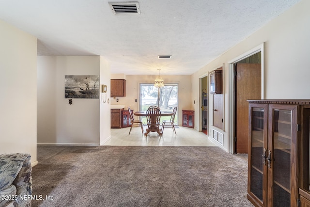 dining space with light carpet, a textured ceiling, and a chandelier