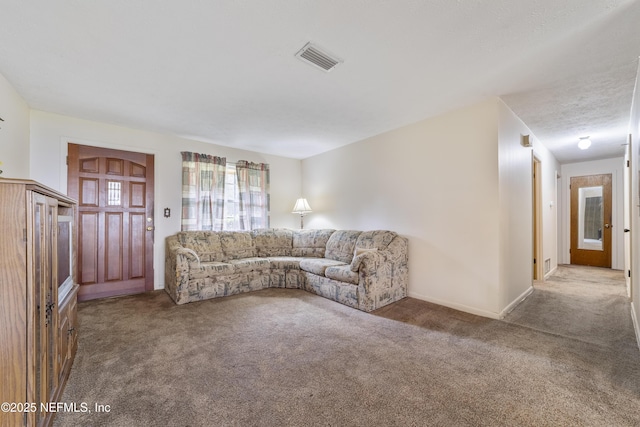 unfurnished living room featuring light colored carpet and a textured ceiling