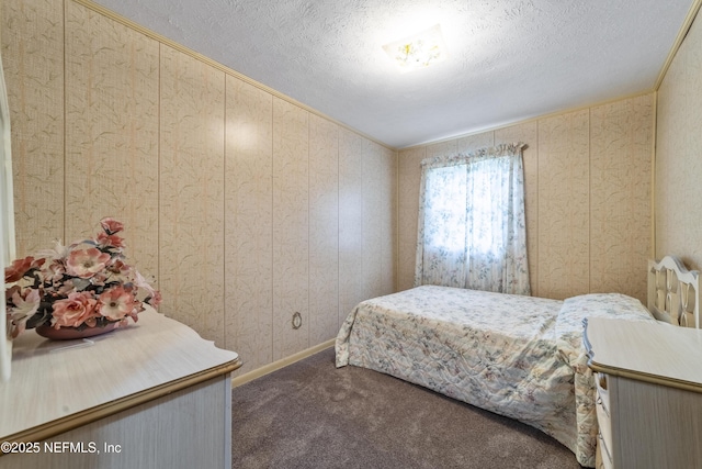 carpeted bedroom with wooden walls and a textured ceiling