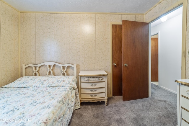 bedroom with wooden walls, carpet floors, a textured ceiling, and ornamental molding