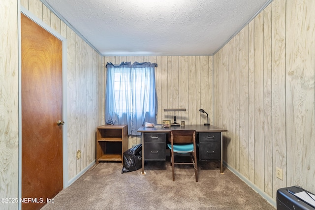 carpeted office featuring wooden walls and a textured ceiling