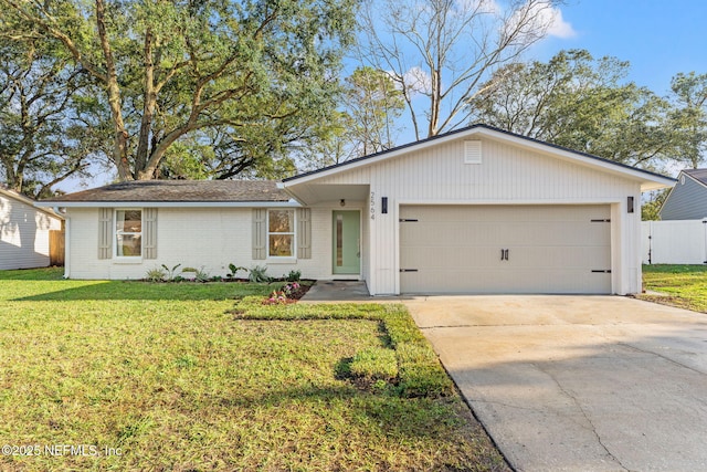 ranch-style home with a garage and a front lawn