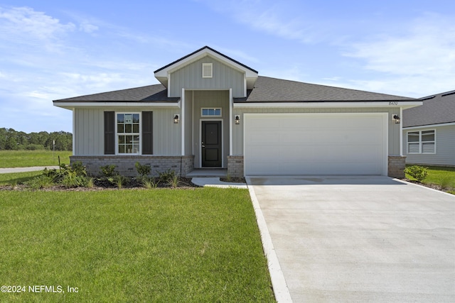 view of front of home with a garage and a front lawn