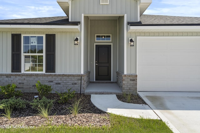 view of exterior entry with a garage